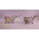 A pair of silver sauce boats with cut, flared rims and S-scrolled handles,