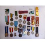 Approximately twenty commemorative, service and civic medals from around the world, many on ribbons,