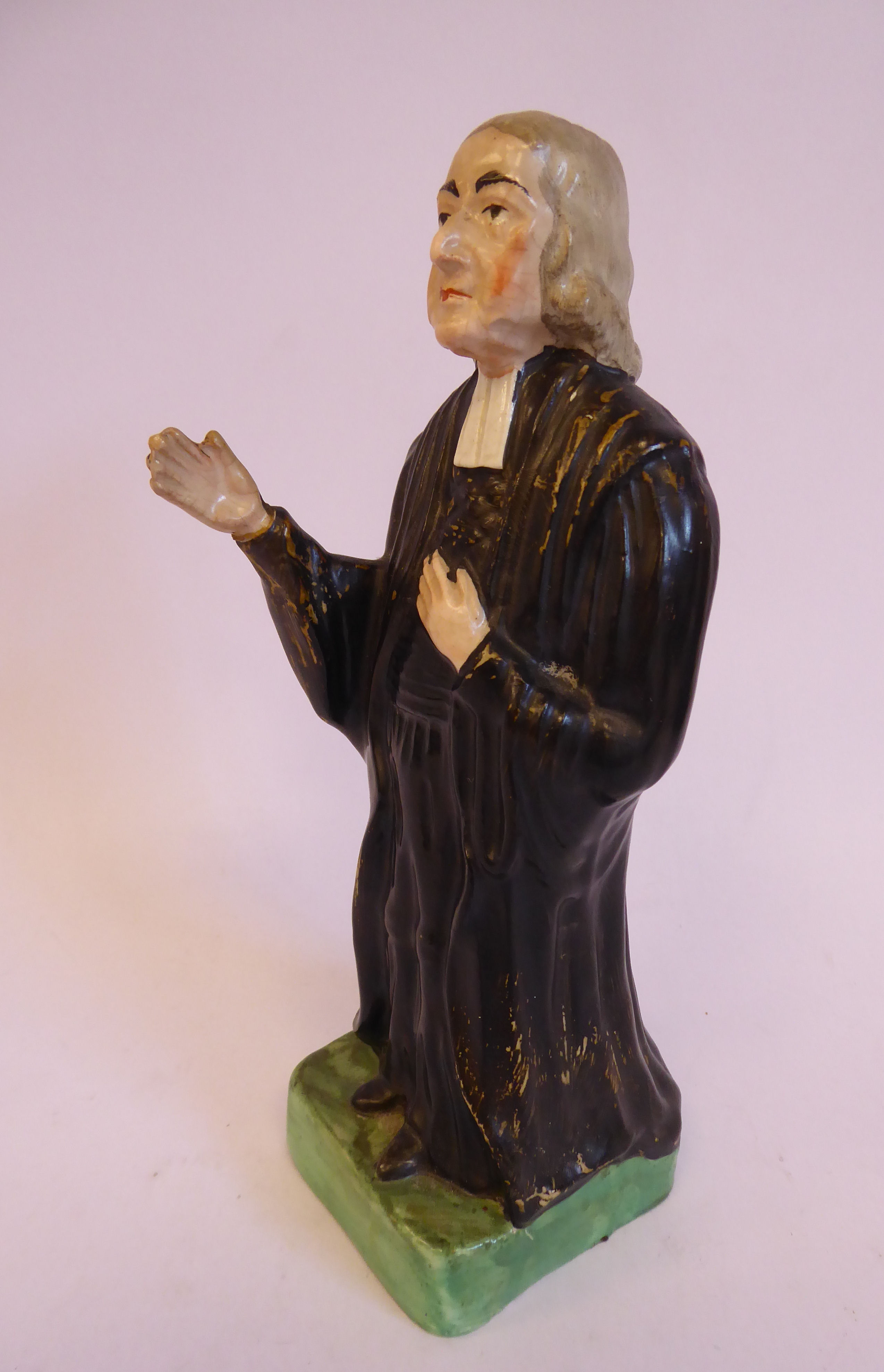 A 19thC Staffordshire pottery figure, John Wesley, wearing a black surplus and white cravat, - Image 2 of 5