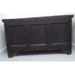 A mid 18thC oak chest with a rising planked top and a lunette and diamond carved,