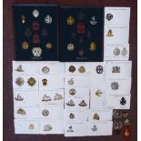 Approximately fifty military and related cap badges and other insignia,