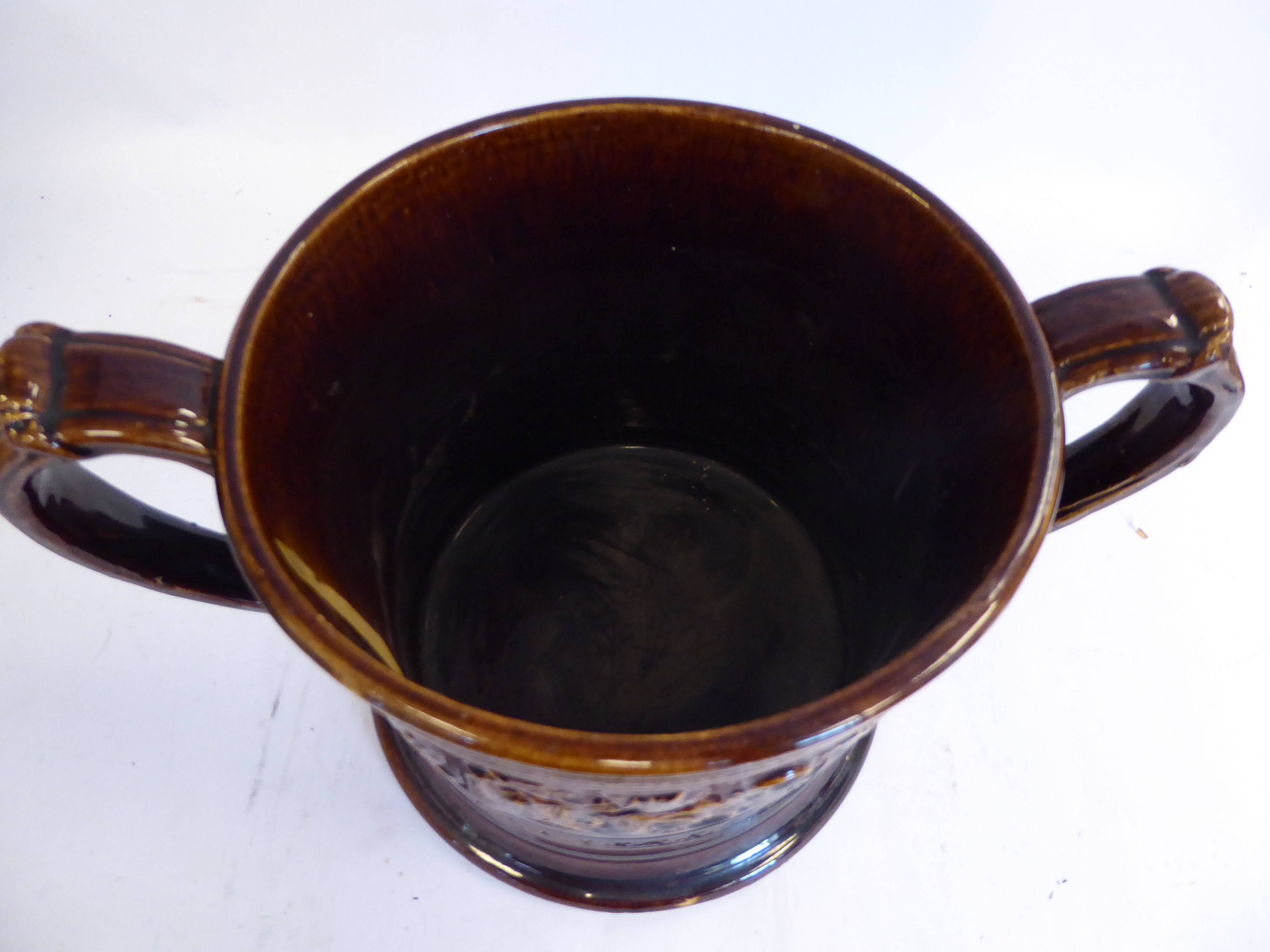 A mid 19thC treacle glazed earthenware 'oversize' loving cup with straight sides, - Image 2 of 7