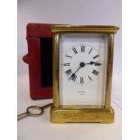 A late 19thC lacquered brass cased carriage timepiece with bevelled glass panels and a folding top