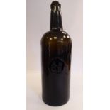A late 18thC opaque dark green/black glass wine bottle of shouldered form with a tapered neck,