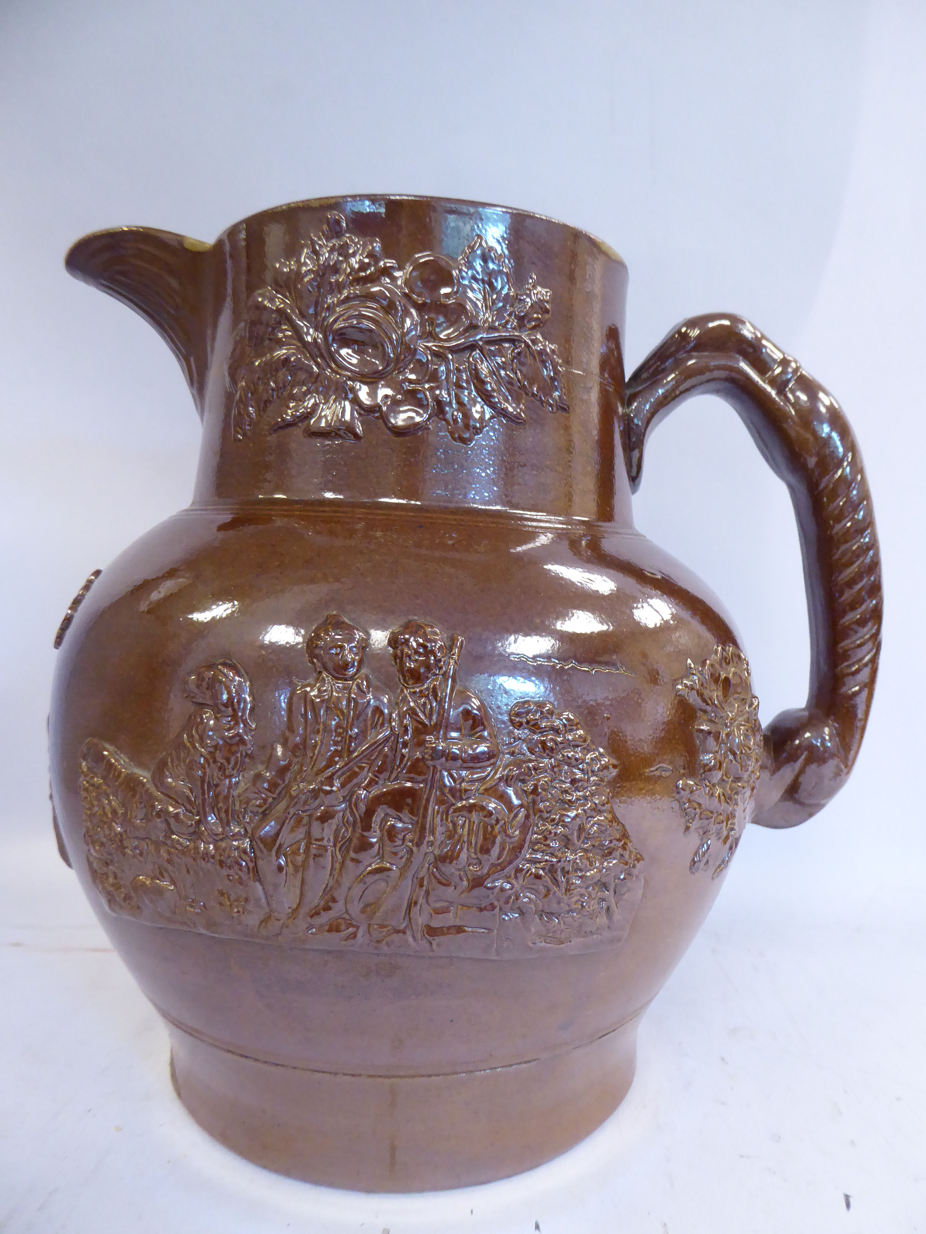 A mid 19thC salt glazed stoneware harvest jug, having an upstand neck and hound handle,