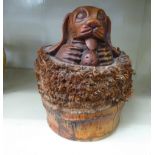 A carved and stained bamboo novelty doorstop,