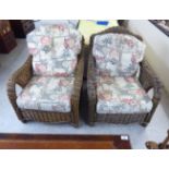 A pair of modern woven cane verandah chairs with cushioned seats BSR