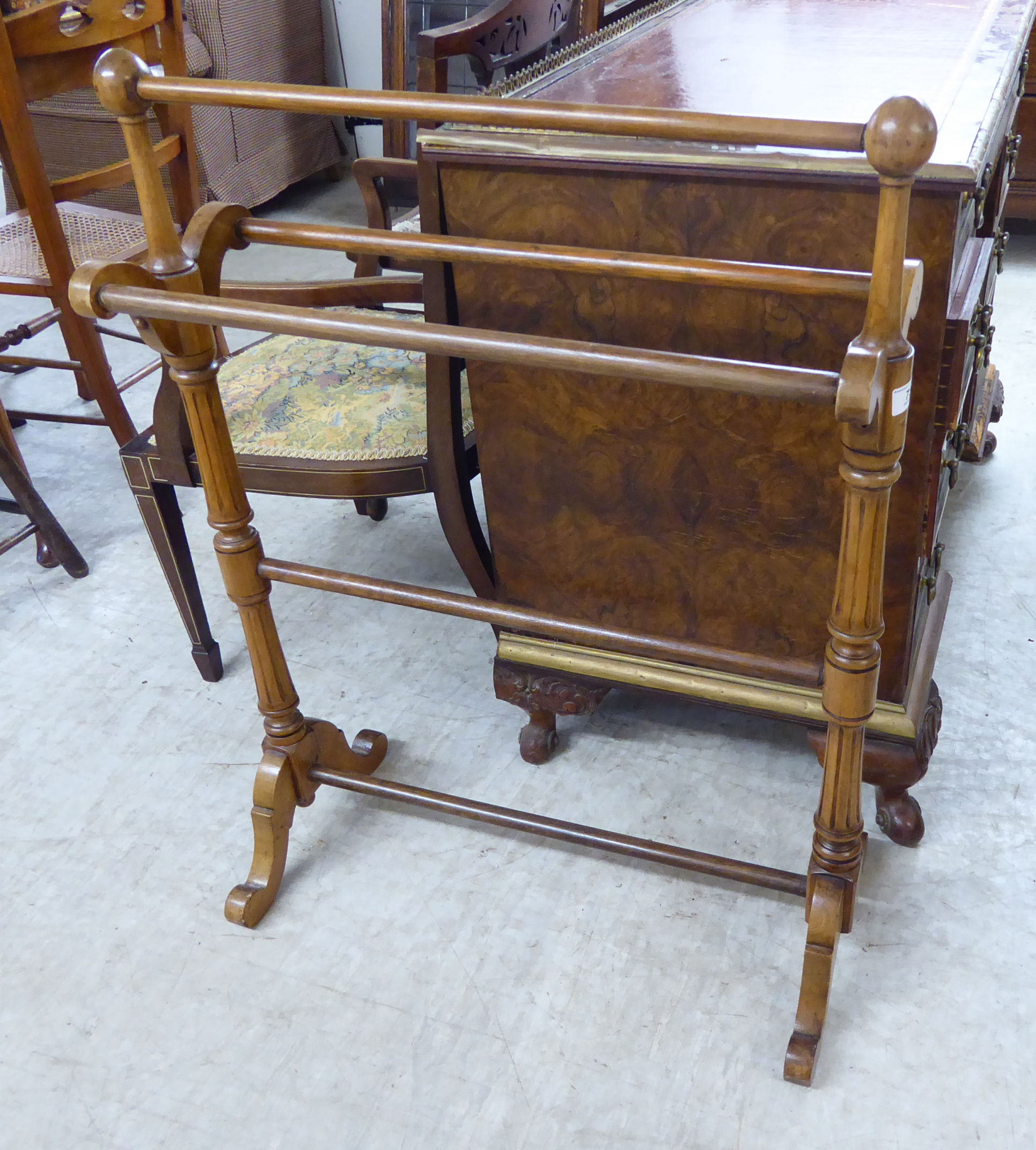 A late Victorian mahogany freestanding towel rail, on fluted uprights with knob finials,