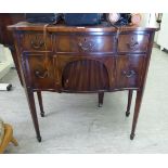 An early 20thC Regency design mahogany and satinwood string inlaid, serpentine front sideboard,