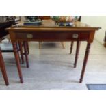 A mid 19thC mahogany bow front side table, the shallow frieze drawer with brass ring handles,