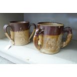 Two similar mid/late 19thC two tone brown glazed stoneware, triple handled,