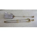 A set of three 19thC polished steel and brass long handled fire companions comprising a hearth