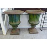 A pair of late 19th/early 20thC cast iron terrace urns of pedestal vase design with fluted and