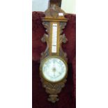 A late Victorian oak barometer with an enamelled dial and thermometer 35''h LSB