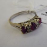 An 18ct white gold claw set ruby and diamond ring 11