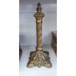 An early 20thC Continental cast gilt metal lamp base of column design with ornately fashioned,