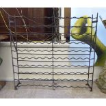 An early 20thC painted wrought iron one hundred and eight bottle wine rack 40''h 43''w F