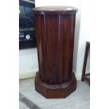 A late Victorian mahogany fluted cylindrical pot cupboard,