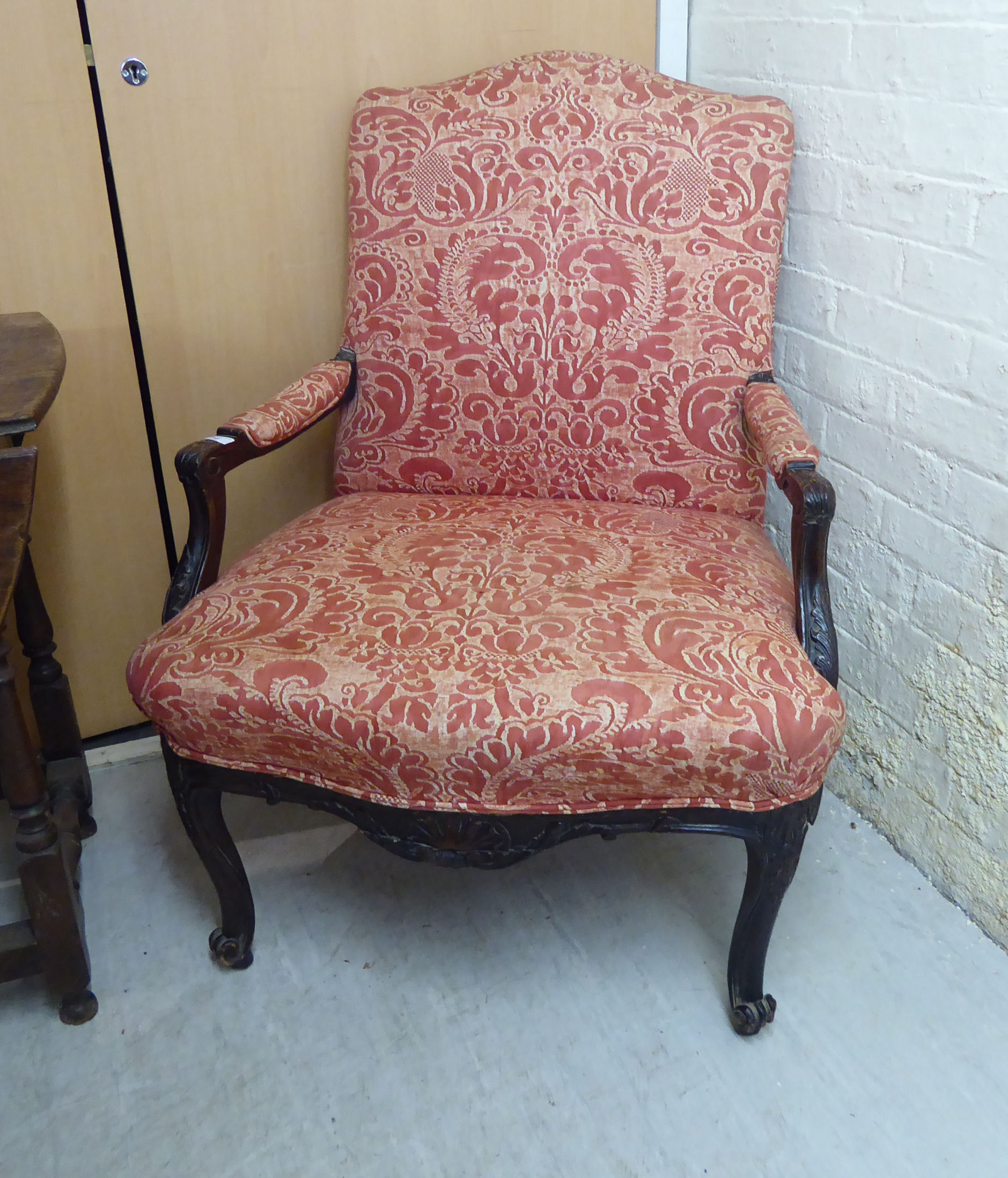 An early 20thC stained and carved beech showwood framed salon chair,