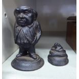 A late 19thC EG Zimmerman cast iron novelty vesta holder, featured as a standing portly man,