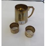 A silver tankard of tapered form with a hollow loop handle; and a pair of silver,