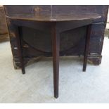A George III stained oak drop leaf table, raised on square,