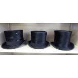 Three black silk top hats, viz. HBB 22.25'' circ. 7.5'' x 22.5''; Christy's 22.5'' circ. 7.