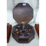 A late Victorian octagonal, mahogany spittoon with inlaid border ornament,
