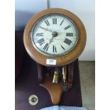 A Victorian and later wall clock in a turned mahogany surround;