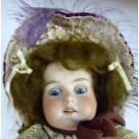 An early 20thC Armand Marseille bisque head doll with painted features and weighted sleeping eyes,