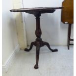 A 1930s mahogany Georgian style tip-top pedestal table with a thumb moulded piecrust border,