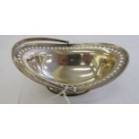 An Edwardian silver oval sweet basket with an engraved, pierced foliate,