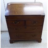 An early 19thC country made honey coloured oak bureau,