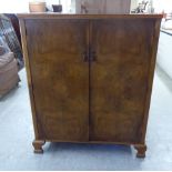 A mid 20thC figured walnut veneered compactum,