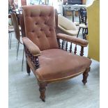 A late Victorian mahogany framed library chair with a high, scrolled back,