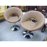 A pair of modern faux brown hide upholstered swivel chairs,