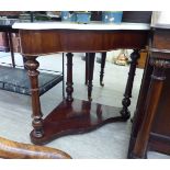 A late Victorian mahogany serpentine front quadrant washstand with a mottled grey/white marble top,