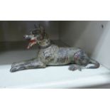 An early 20thC painted cold cast bronze model, a seated dog (possibly a Doberman),