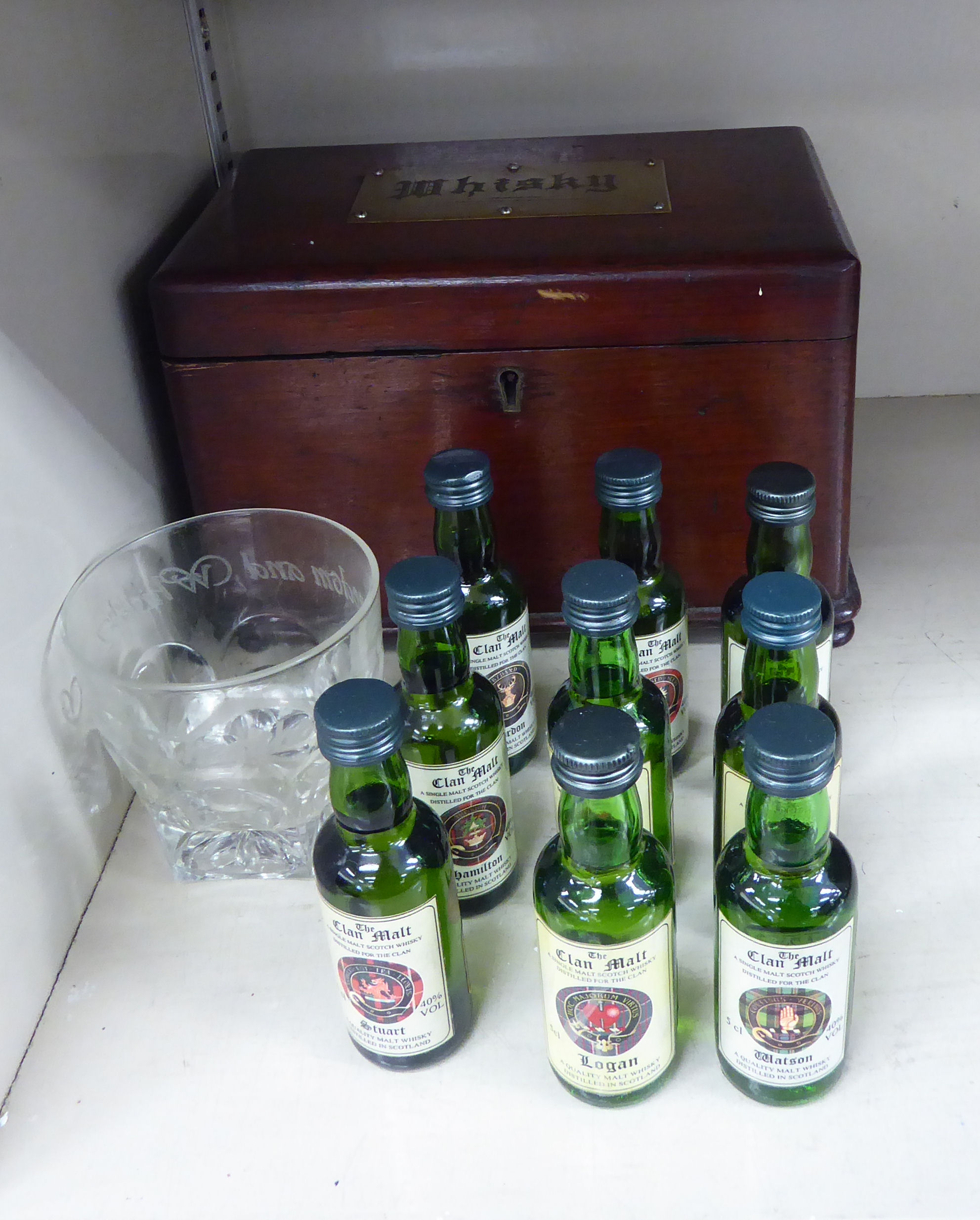 A mid 19thC stained pine casket with straight sides and a lockable hinged lid, on bun feet,