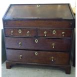 A George III oak bureau with a fall-flap, over two short/two long drawers,