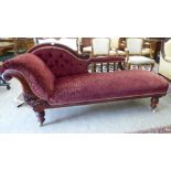 A late Victorian mahogany framed chaise longue, upholstered in a maroon floral fabric,