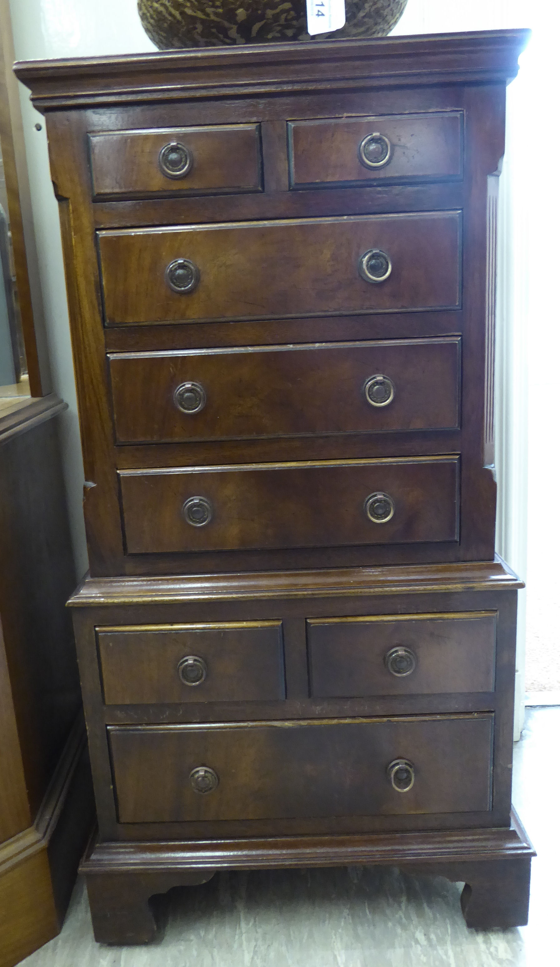 A Reprodux crossbanded mahogany miniature chest-on-chest with four short/four long drawers,