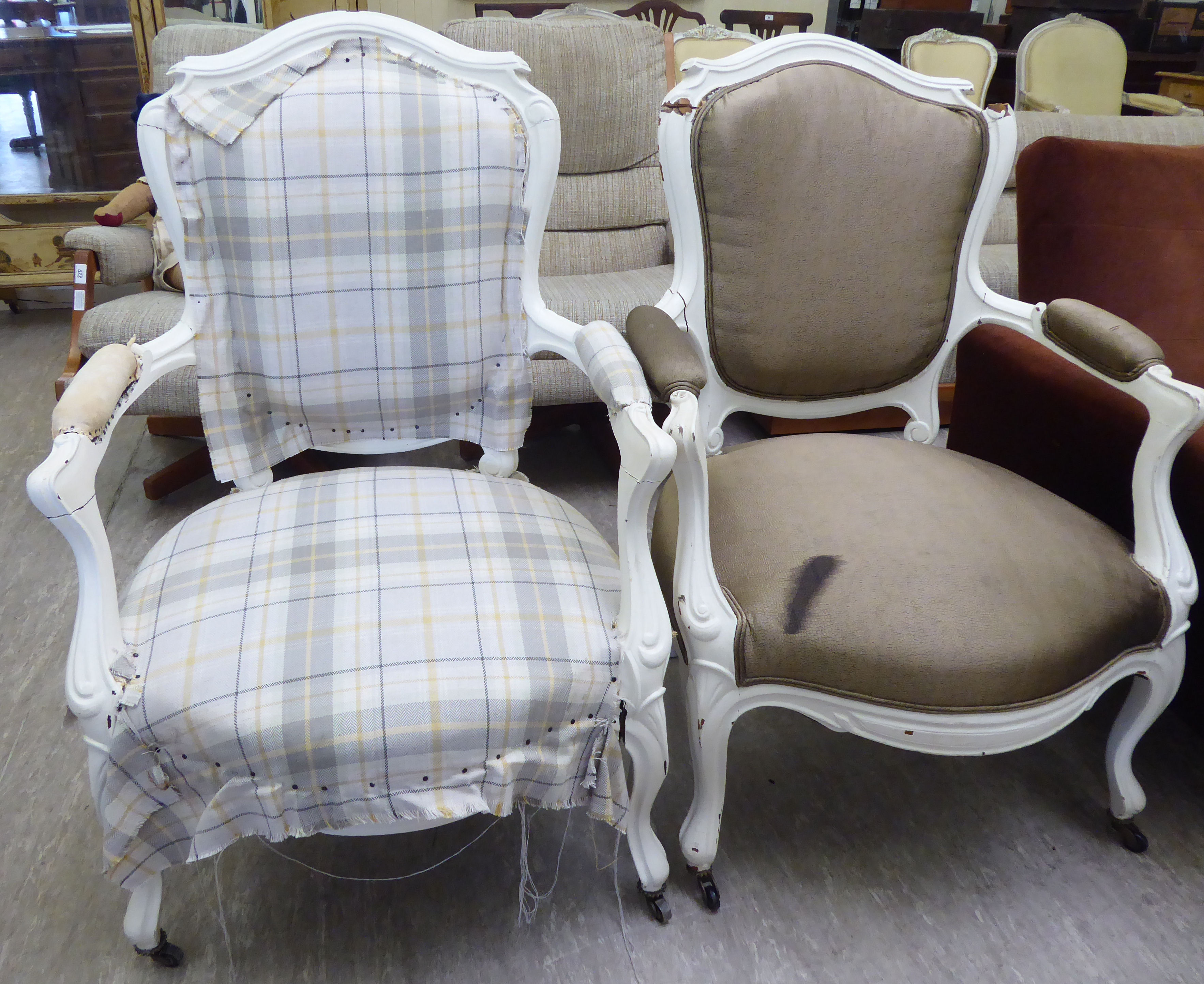 Two similar mid 20thC French inspired, white painted elbow chairs, the fabric upholstered backs,
