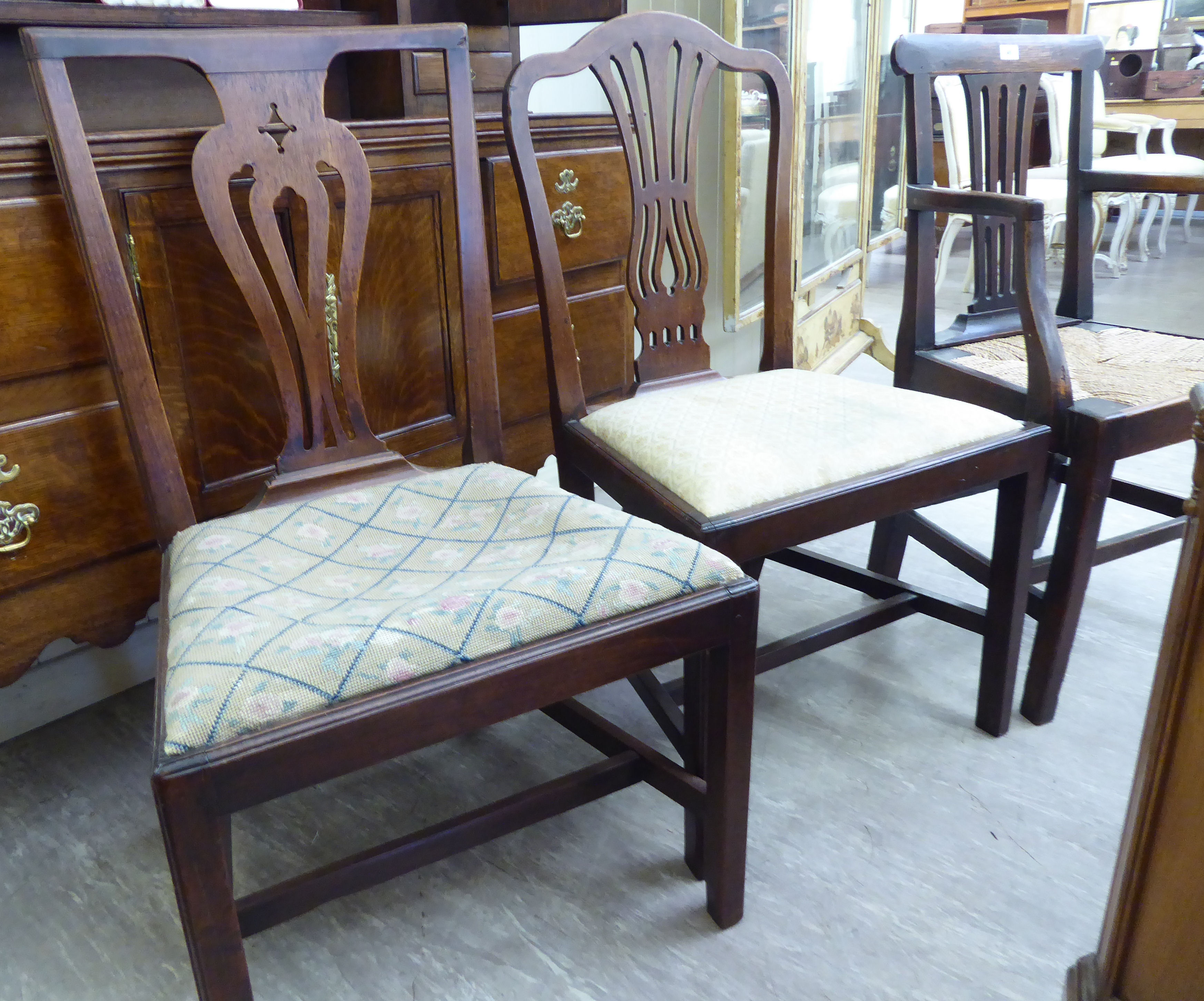 Two similar Georgian mahogany dining chairs with upholstered drop-in seats,