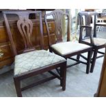 Two similar Georgian mahogany dining chairs with upholstered drop-in seats,