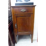 An Edwardian crossbanded mahogany bedside cabinet with a single drawer, over a panelled door,