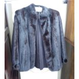 A black mink jacket with a swing back and detailed cuffs approx.