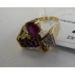 A designer 14ct gold ruby and diamond set ring 11