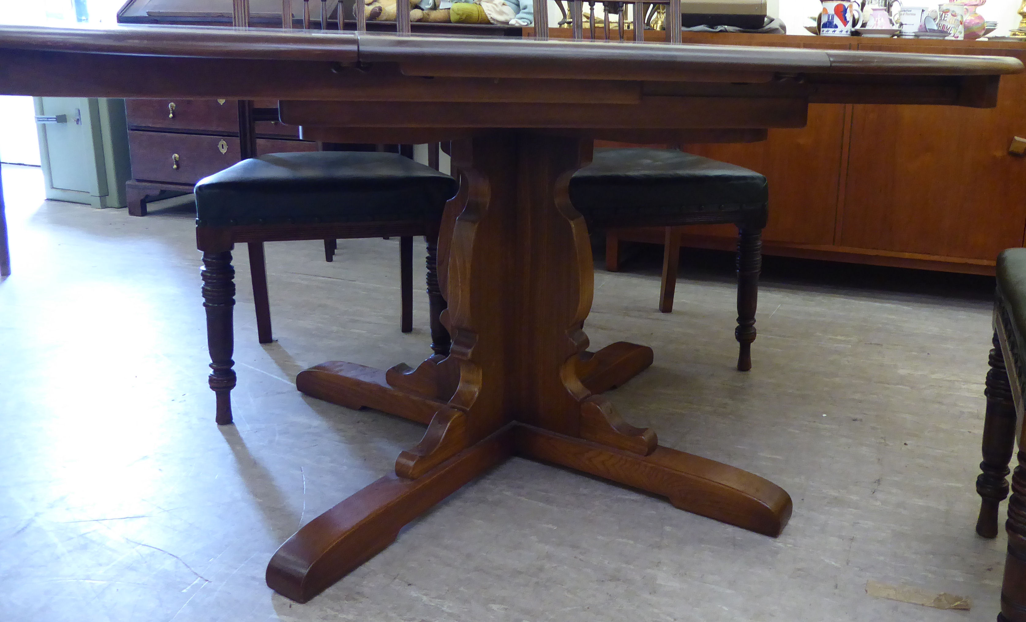 An Ercol elm draw leaf dining table,