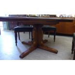An Ercol elm draw leaf dining table,